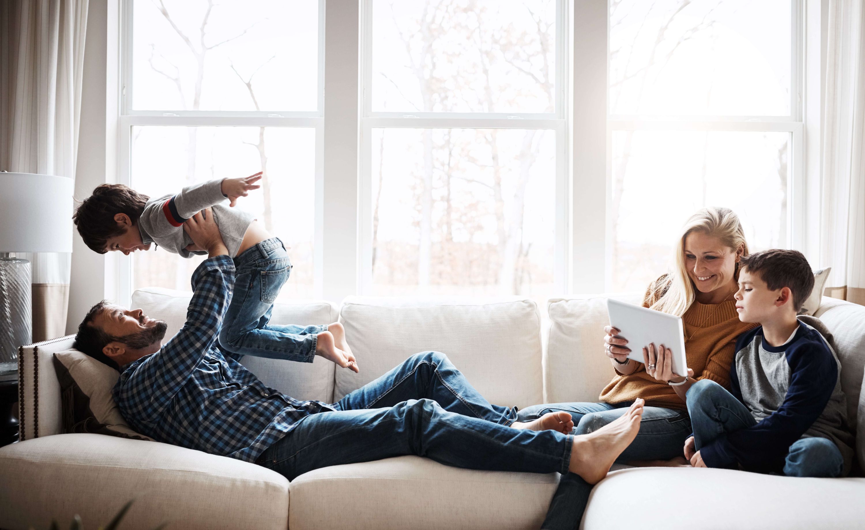 Family of four hanging out on couch