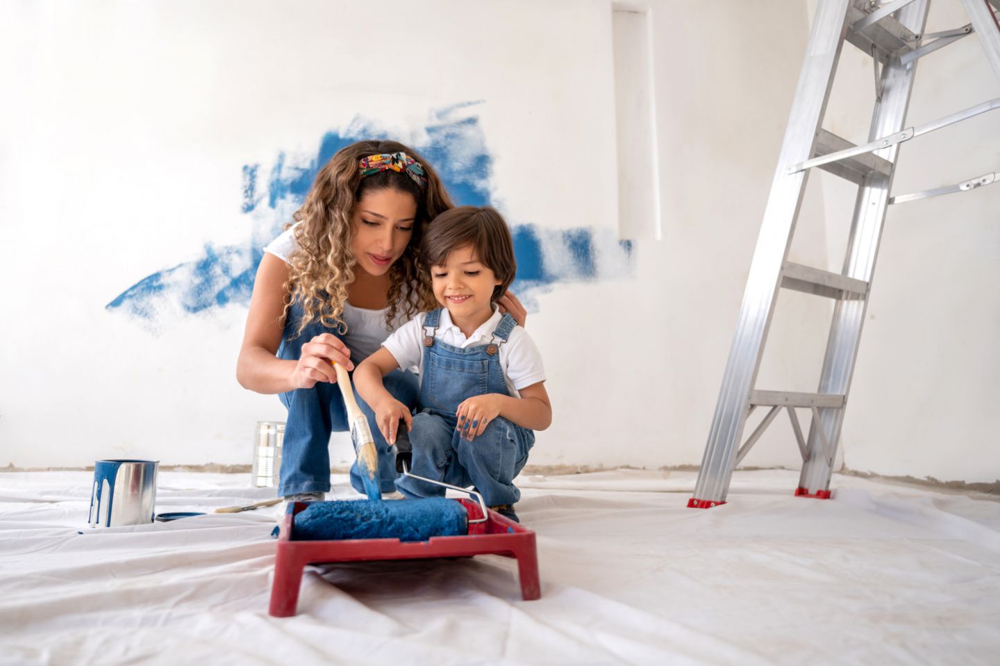 Mother and child painting house
