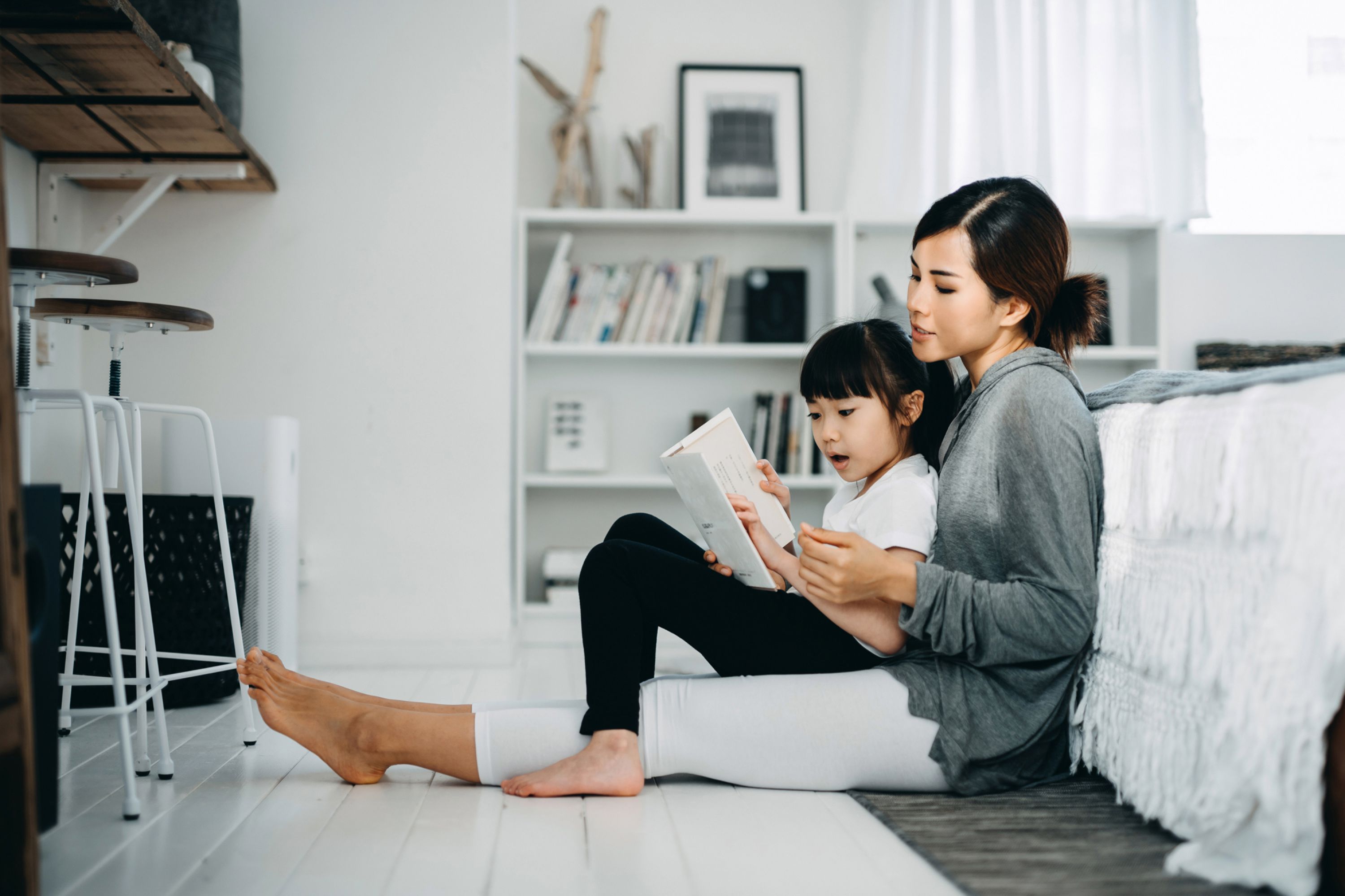 Refinance Mother and daughter reading at home